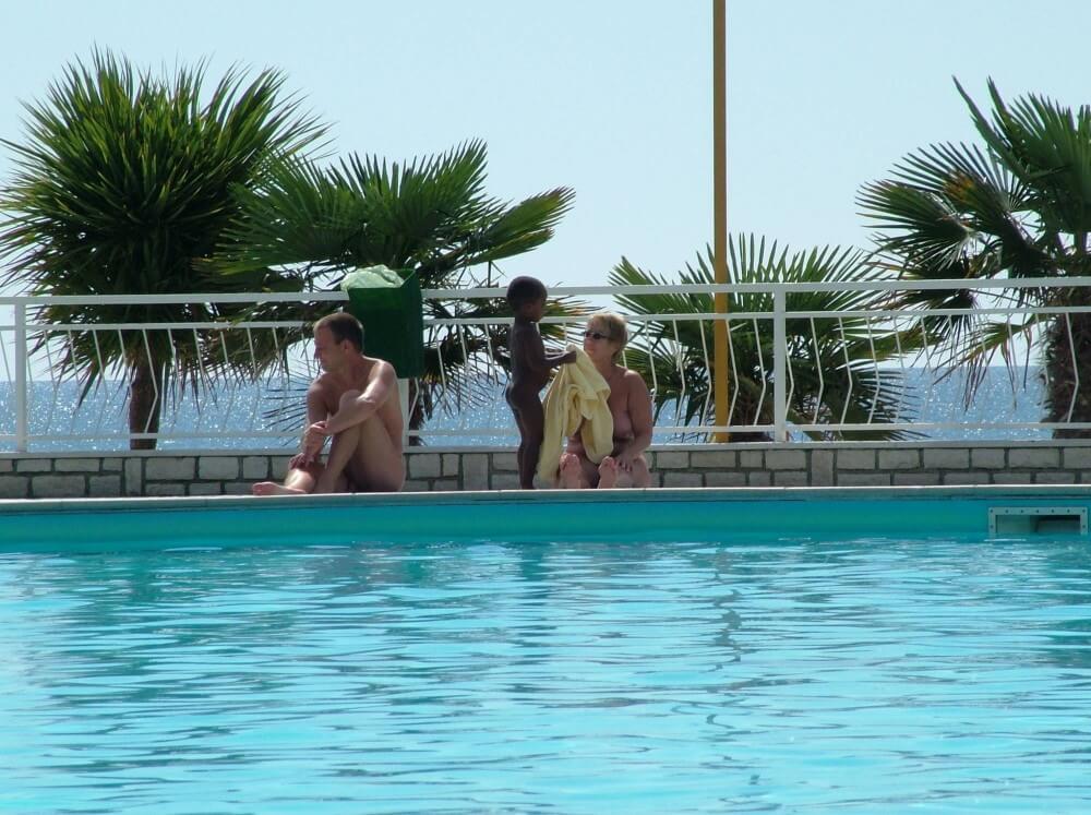 Photo of naturists in an outdoor pool - Respect for one another and for the natural world are key principles of nudism and naturism
